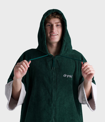 *MALE* Person wearing a green hooded garment on a white background
