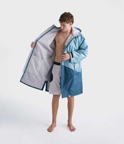 *MALE* Person wearing a blue and gray hooded Dryrobe on a white background