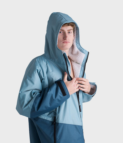 *MALE* Person wearing a blue Dryrobe with a hood on a white background