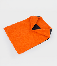 Black and orange cushion cover with Dryrobe® logo on a white background showing orange fleece inside