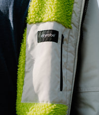 Close-up of a Dryrobe with green fleece lining and 'dryrobe' logo.