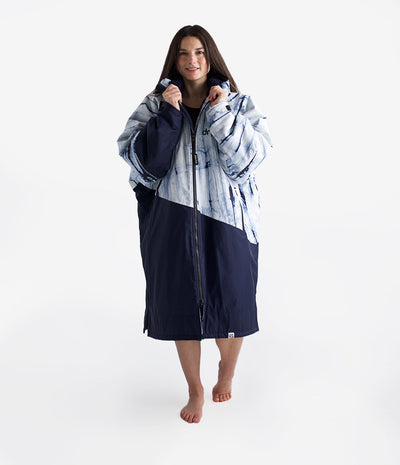 Woman wearing a long navy patterned Dryrobe on a white background