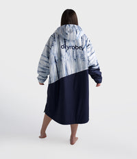Person wearing a tie-dye robe with 'dryrobe' branding on a white background