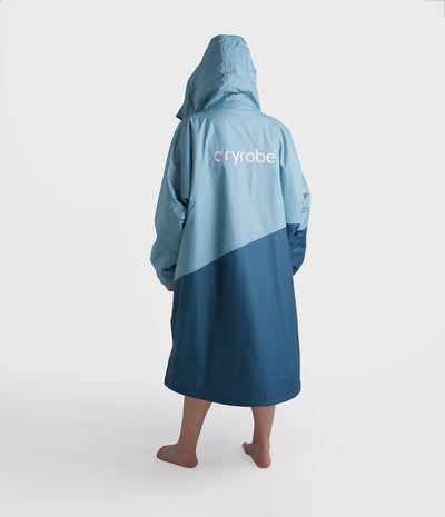 Person wearing a two-tone blue Dryrobe with 'dryrobe' branding on a white background