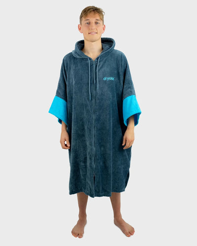 *MALE* Person wearing a blue and grey hooded towel robe with 'dryrobe' branding on a white background
