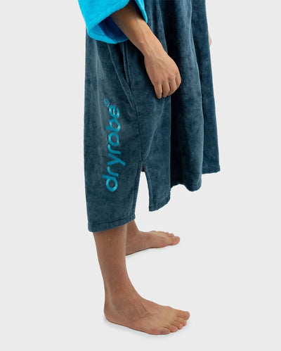*MALE* Person wearing a blue towel with 'dryrobe' branding on a white background