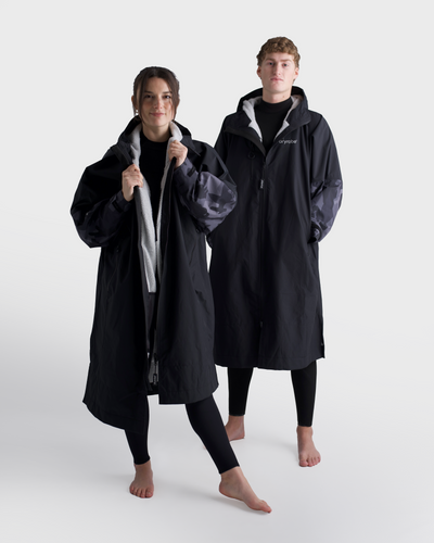 Two people wearing black tech-lite on a white background