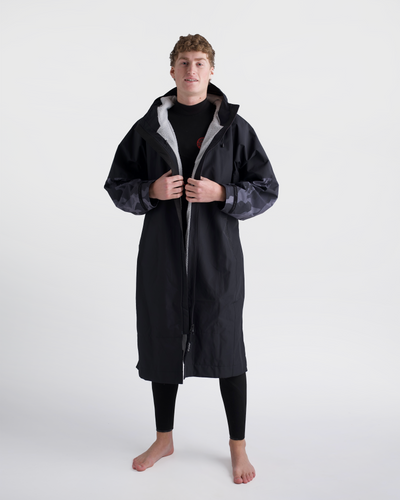 *MALE*Person wearing a long black coat with grey hood on a white background