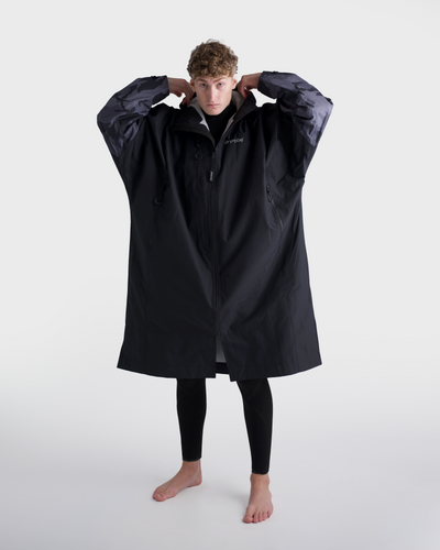 *MALE*Person wearing a black raincoat on a white background