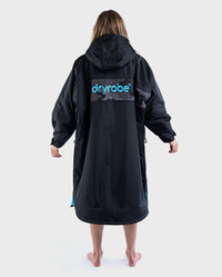 Woman with back to the camera, wearing Black Blue Camo dryrobe® Advance REMIX Range