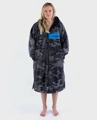 Woman wearing dryrobe Advance Long Sleeve REMIX Range change robe in Black Camo Black Blue