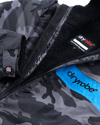 Close up of logo on dryrobe Advance Long Sleeve REMIX Range change robe in Black Camo Black Blue