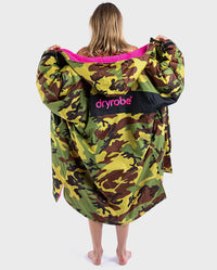 Woman wearing dryrobe Advance Long Sleeve REMIX Range change robe in Camo Pink Black with back to the camera