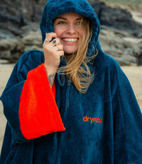 Female adult wearing Dryrobe® full zip towel on the beach
