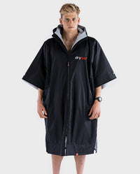 Man facing camera wearing Black Grey dryrobe® Advance Short Sleeve 