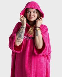 Woman wearing dryrobe® Organic Cotton Towel Robe in Pink with the hood up 