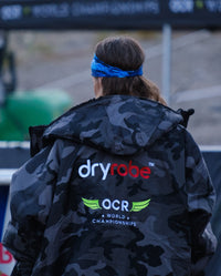 Person stood with back to the camera wearing OCR dryrobe® Advance Limited Edition change robe 