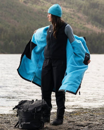 Female takeing off Dryrobe® Advance to reveal Dryrobe® fleece gilet