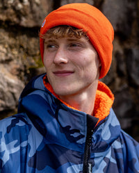 Man wearing Orange dryrobe Beanie and Blue Camo dryrobe Advance changing robe 