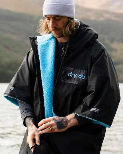 Adult male by lake wearing black blue remix Dryrobe®