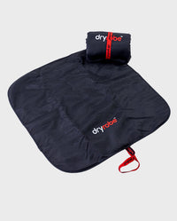 Rolled up Black Red dryrobe® Change Mat, placed on top of one laid out flat