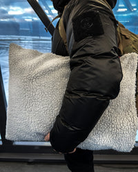 Person holding a stuffed dryrobe® Cushion Cover under their arm