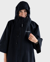 Woman smiling wearing dryrobe® Lite changing robe with hood and zip up