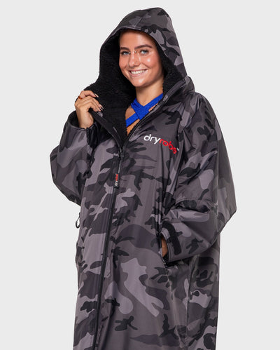 Woman wearing Black Camo dryrobe® Advance Long Sleeve with hood up