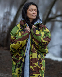 Woman stood with eyes closed, wearing Camo Grey dryrobe® Advance Long Sleeve