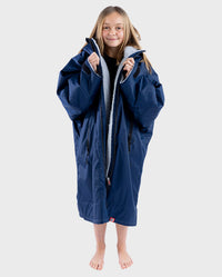 Girl smiling wearing Navy Grey dryrobe® Advance Kids Long Sleeve unzipped