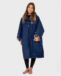 Girl smiling wearing Kids dryrobe Advance Short Sleeve change robe in Navy Grey 