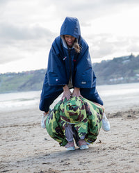 Children playing a jumping game wearing dryrobe® Advance Kids