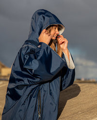 Girl smiling in the sun wearing Navy Grey dryrobe® Advance Kids Short Sleeve