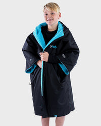 Boy wearing Black Blue dryrobe® Advance Kids Short Sleeve changing robe unzipped