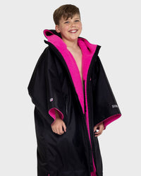 Boy wearing Black Pink dryrobe® Advance Kids Short Sleeve changing robe unzipped