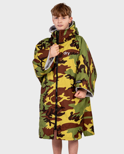 Boy wearing dryrobe Advance Short Sleeve changing robe in Camo Grey