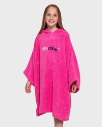 Girl smiling wearing Kids Towel Robe in Pink 