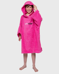 Boy smiling wearing Kids Towel Robe in Pink, with hood up 