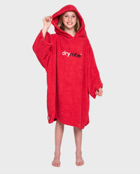 Girl wearing Red Kids Organic Towel robe with hood up