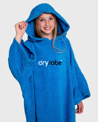 Girl wearing Cobalt Blue Kids Organic Towel robe with hood up