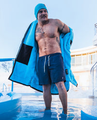 *MALE* stood in pool, taking off Black Blue dryrobe® Advance Long Sleeve