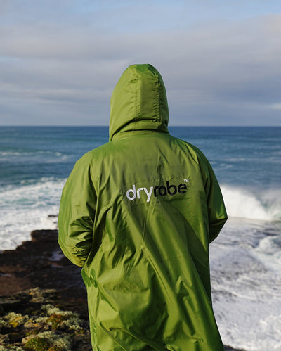 *MALE* wearing Forest Green Dryrobe Advance Long Sleeve with hood up