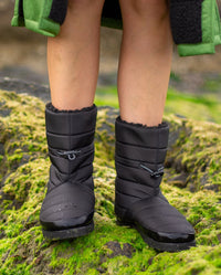 1|Person stood on rocks covered in seaweed, wearing dryrobe® Eco Thermal Boots