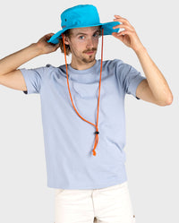 *MALE* Man wearing dryrobe® Quick Dry Brimmed Hat in Blue, holding the brim 